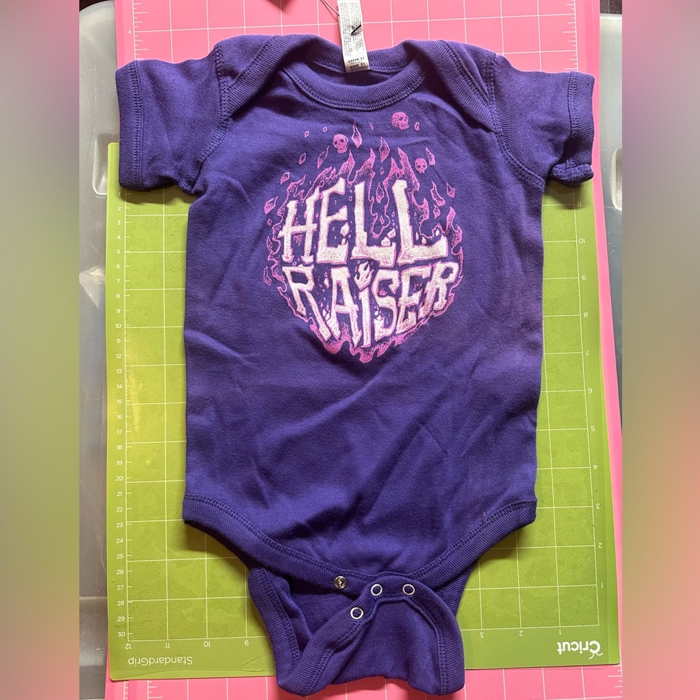 Cute purple onesie that says Hellraiser